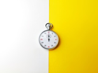 Analog Stop watch isolated and symmetry over white and yellow background