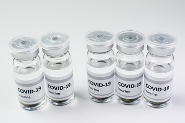 Coronavirus vaccine bottle flipped isolated on black background. Covid-19 situation disease pharmacy in laboratory and drug to cure people.  Healthcare and Medical concept. Development of research.