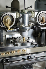 Cookies making process, many raw cookies on conveyor belt