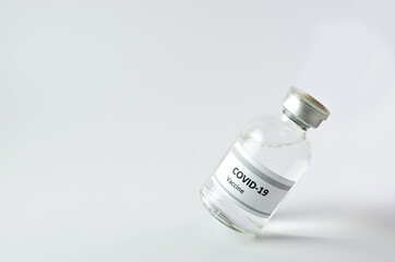 Coronavirus vaccine bottle flipped isolated on black background. Covid-19 situation disease pharmacy in laboratory and drug to cure people.  Healthcare and Medical concept. Development of research.