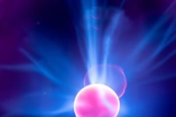 Plasma electric ball lightning lamp. Fascinating space video, close-up of electrical discharges with blue flames on a dark background