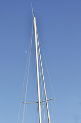 Fototapeta premium Blue sky, sunny summer day and white lines. Part of sailboat and small white moon. Minimal Summer composition.