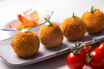 Traditional spanish croquettes from mallorca with sobrassada and cheese