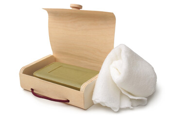 Toilet soap in wooden box and bath towel