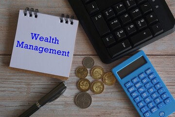 computer keyboard and blue calculator on wooden background. Finance concept.