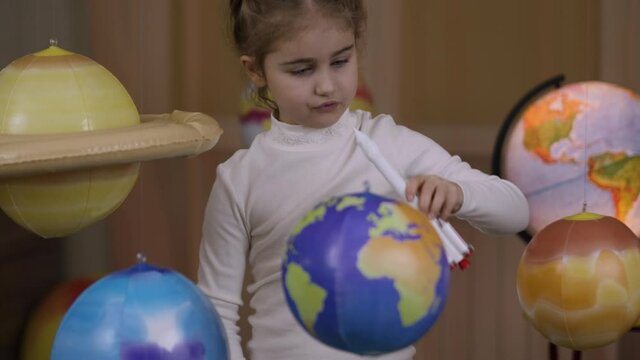 Space Travel Spaceship. Creative Little Girl Astronaut Launching Rocket From Spaceport Through Planets. Child Dreamer Playing Space Rocket Flying Among Planets. Spaceman Fantasy Flying on Spacecraft.