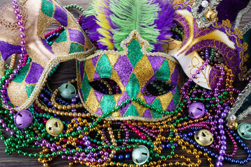 A group of Venetian and New Orlean Mardi gras mask with colorful beads on dark background © vetre