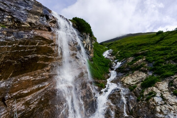gorgeous high waterfall over a cliff in the mountains