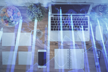 Stock market graph and top view computer on the table background. Multi exposure. Concept of financial education.