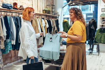 Fashion store owner assisting customer