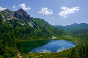 deep blue mountain lake in a green wonderful landscape in the summer