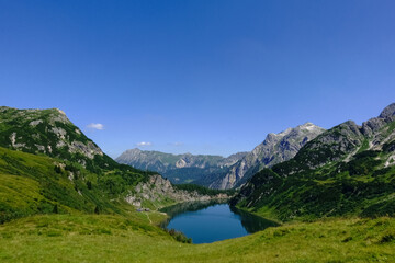Fototapeta na wymiar gorgeous deep blue lake in a mountain landscape with blue sky