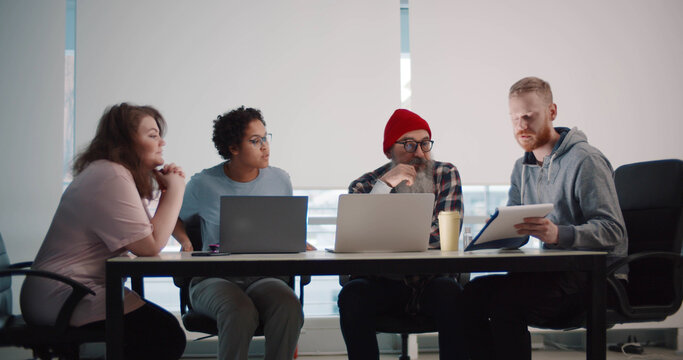 Diverse creating team meeting in board room discussing ideas