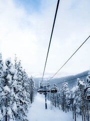 A view from a ski lift on a snowy mountain
