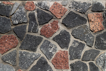 background multicolored red brown gray white black stones with gray cement