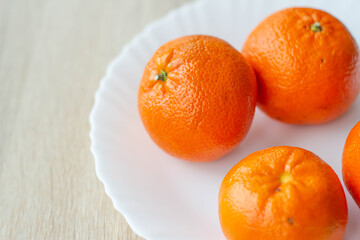 Tangerines are on a white plate