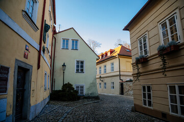Fototapeta na wymiar Fascinating narrow picturesque street with baroque and renaissance historical buildings in sunny day, Novy svet, New World in the vicinity of Hradcany, Prague, Czech Republic