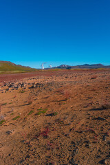 Colorful geothermal active zone Hverir near Myvatn lake in Iceland, resembling Martian red planet landscape, at summer and blue sky.
