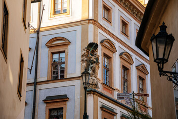 Obraz premium Baroque Tuscan palace at Square nearby Prague Castle in sunny day, view from Town hall stairs, facade is richly decorated with statues, Hradcany district, Prague, Czech Republic