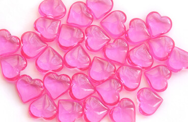 Valentine’s Day background image of pink glass  heart shapes with copy space filling the frame
