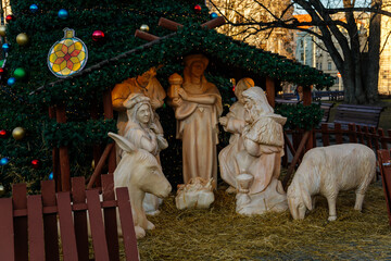 Christmas wooden nativity scene and Christmas tree at Peace Square or namesti Miru in sunny day, Vinohrady Quarte, Prague, Czech Republic
