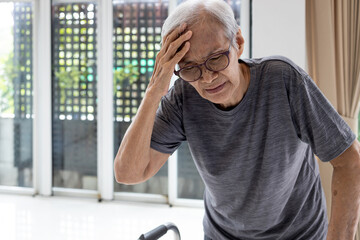 Tired asian senior woman touch her head with hand,symptoms of vertigo illness or meniere’s...