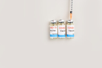 Covid-19 Corona Virus 2019-ncov vaccine vials medicine drug bottles syringe injection. Vaccination, immunization, treatment to cure Covid 19 Corona Virus infection.