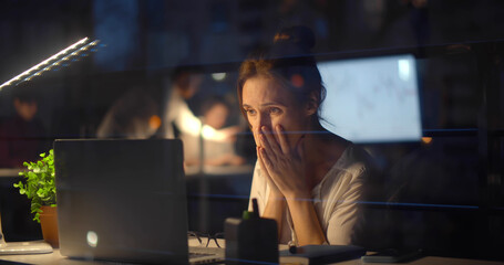 Naklejka premium Stressed businesswoman with computer working at night office