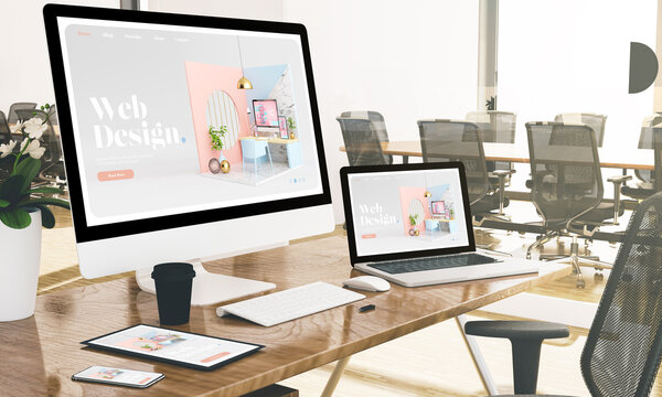 computer, laptop, tablet, and phone with web design at office mockup