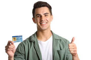 Young man with driving license on white background