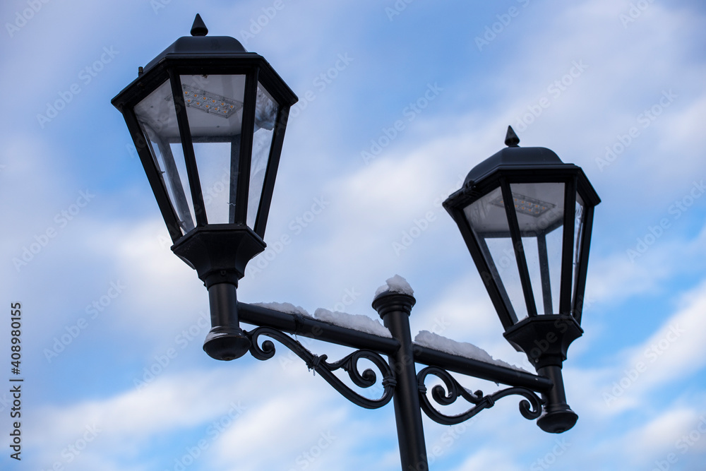 Poster street lamp on the background of the sky with clouds