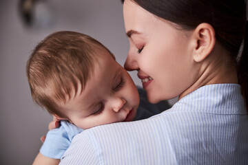 Close up of happy female smelling her baby