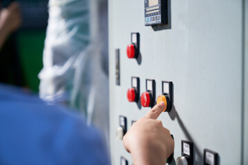 Engineer will pressing on Switch button on control box panel in beverage industry