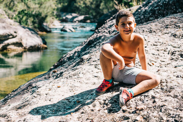 Relaxed child near a river