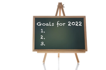 Goals for 2022 written on chalkboard on white background. Business motivation inspiration challenge concept and success idea
