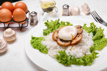 Plate with tasty egg, mushrooms and rice on light background