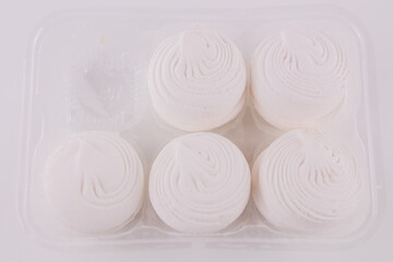 Fototapeta na wymiar delicious white marshmallow on a white background. sweets with marshmallows for a holiday