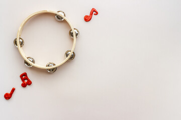 Tambourine with music hotes, flat lay, top view