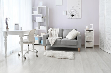 Stylish interior of living room with comfortable sofa