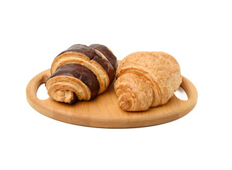two baked croissants lie on a wooden tray, food isolated on white background, top view