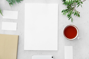 Blank magazine and cup of tea on light background
