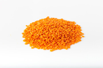Red lentils on white background.