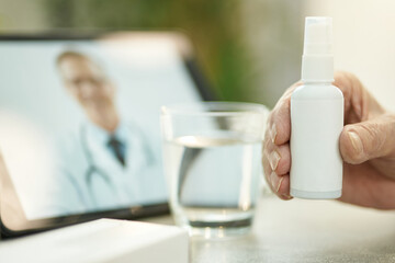 Fototapeta na wymiar Person holding a generic spray bottle with medication