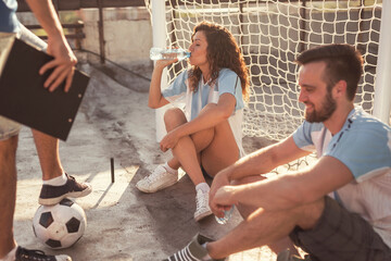 Friends taking a time out while playing football