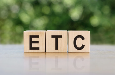 ETC (abbreviation of et cetera) word written on wooden blocks. The text is written in black letters...