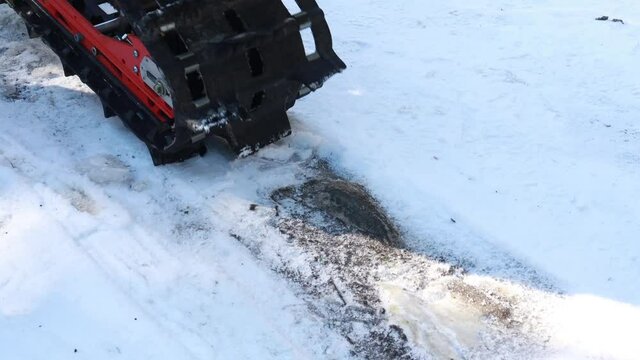 Snow motorcycles in the mountains. Snowbike details in mountain valley in beautiful snow powder. Snowdirt bike with splashes and trail. Wnter sport riding