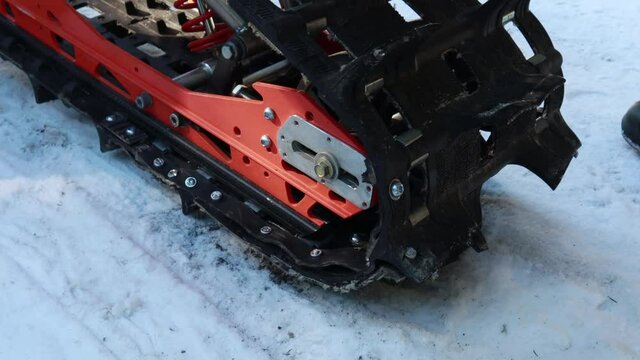Snow motorcycles in the mountains. Snowbike details in mountain valley in beautiful snow powder. Snowdirt bike with splashes and trail. Wnter sport riding