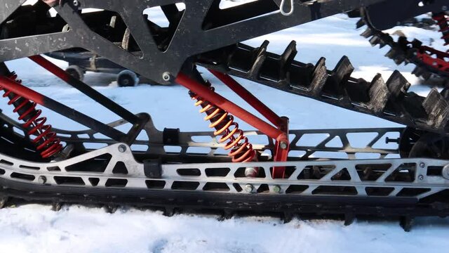 Snow motorcycles in the mountains. Snowbike details in mountain valley in beautiful snow powder. Snowdirt bike with splashes and trail. Wnter sport riding