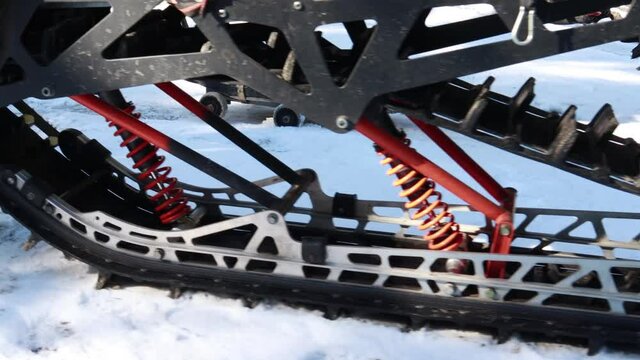 Snow motorcycles in the mountains. Snowbike details in mountain valley in beautiful snow powder. Snowdirt bike with splashes and trail. Wnter sport riding