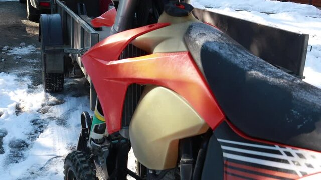 Snow motorcycles in the mountains. Snowbike details in mountain valley in beautiful snow powder. Snowdirt bike with splashes and trail. Wnter sport riding